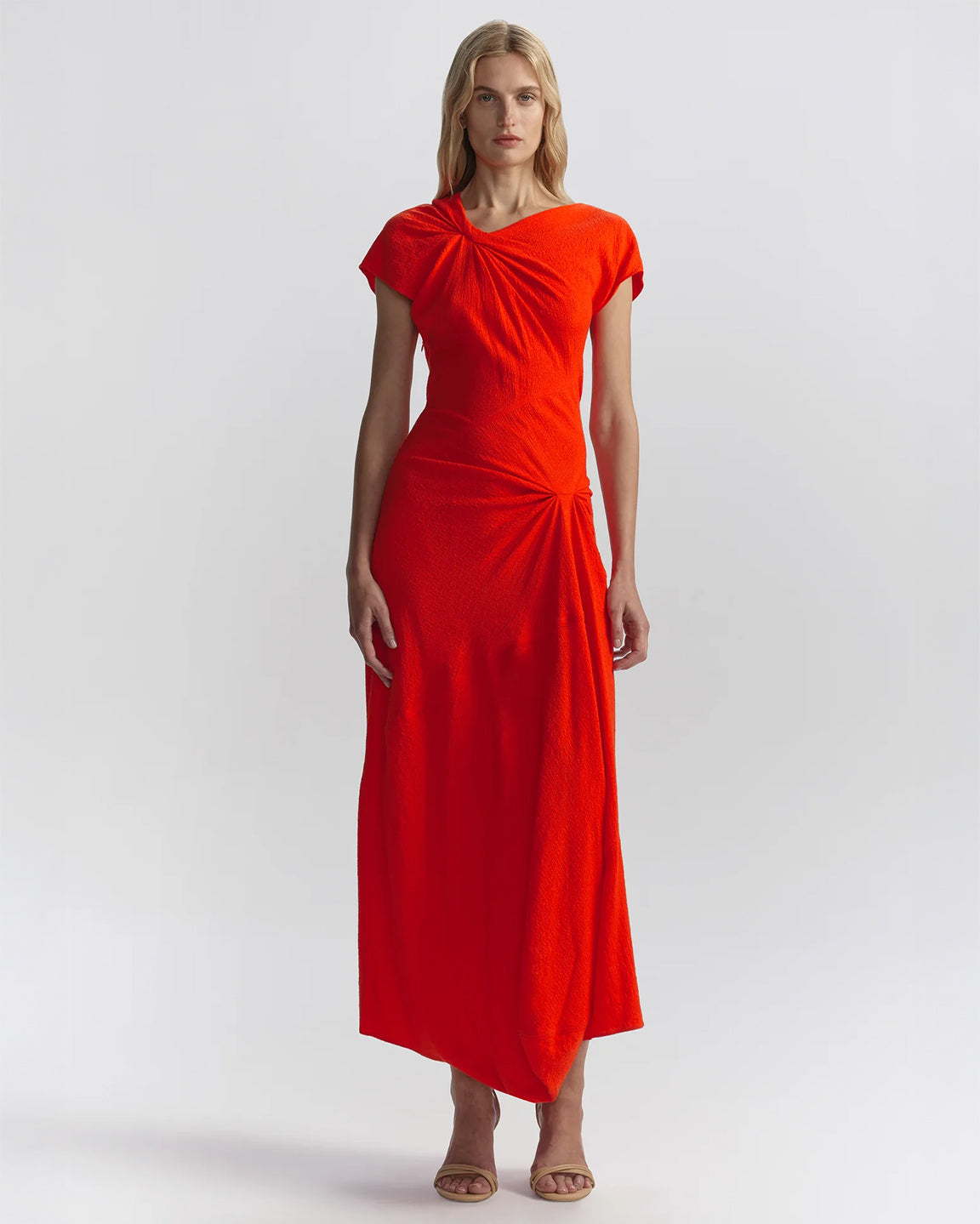 Woman wearing a orange dress on a white background