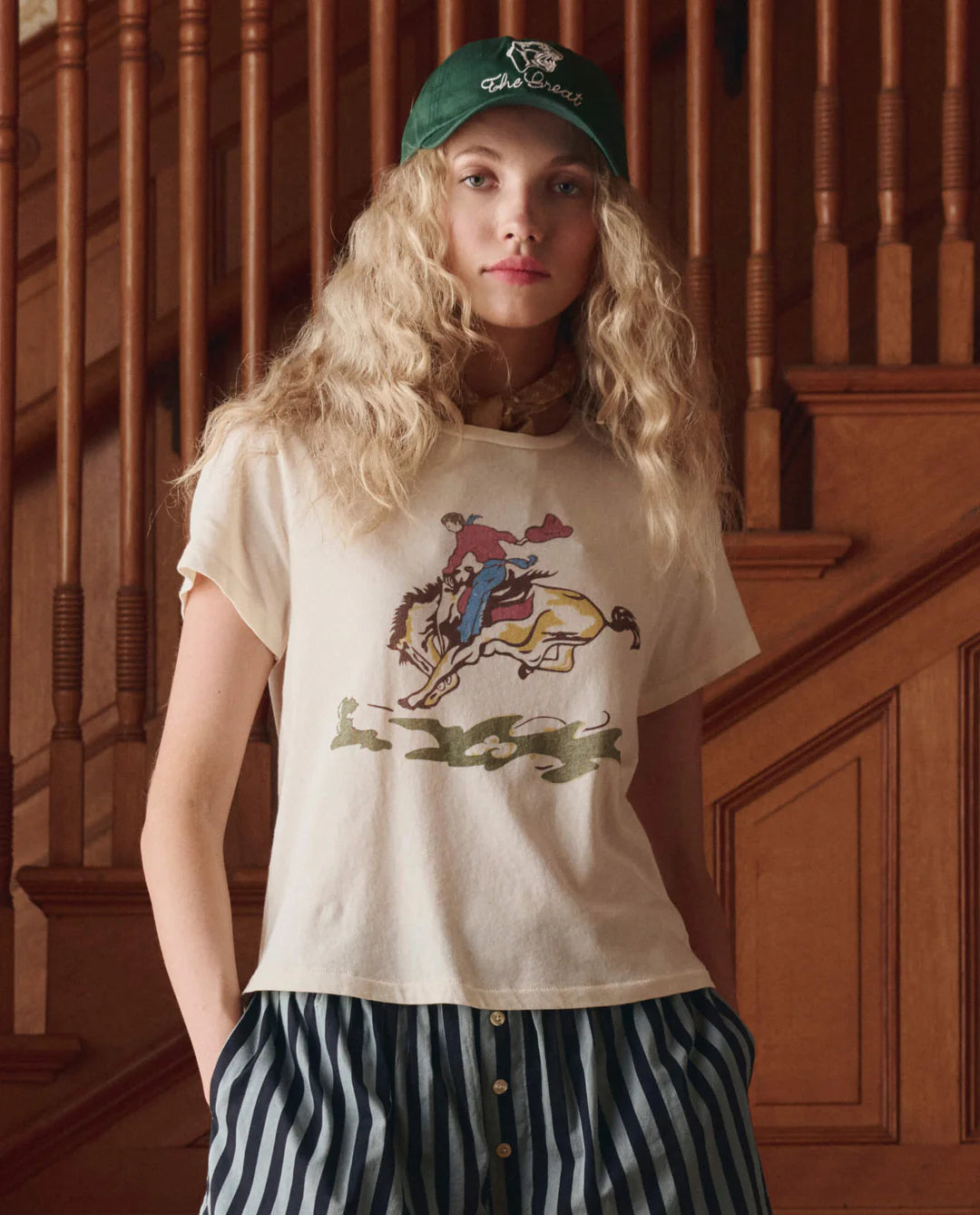 Person wearing a t-shirt with a graphic design in a wooden interior setting