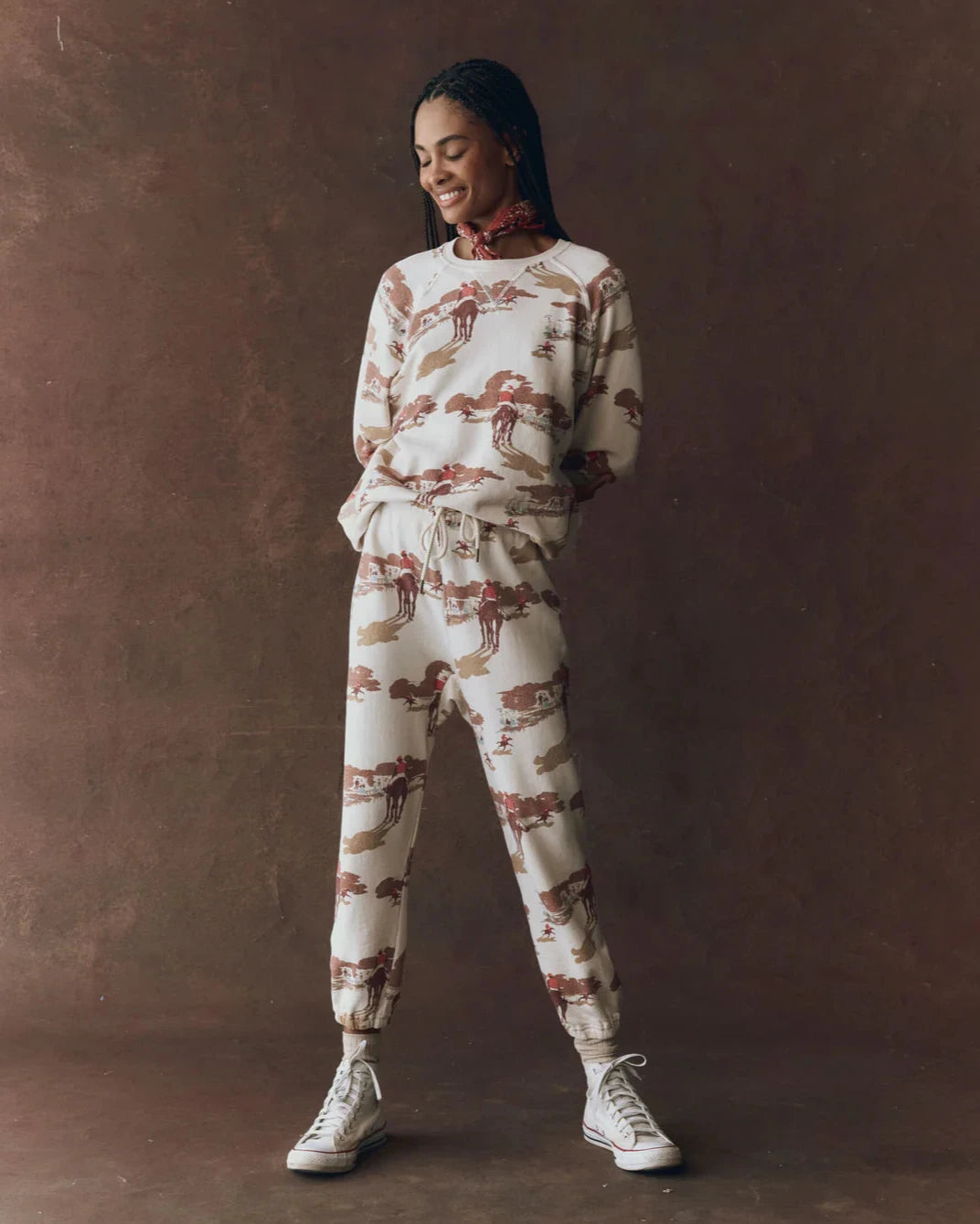Woman wearing a patterned outfit against a brown background