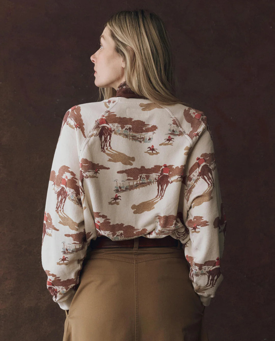 Person wearing a patterned sweater with a brown background