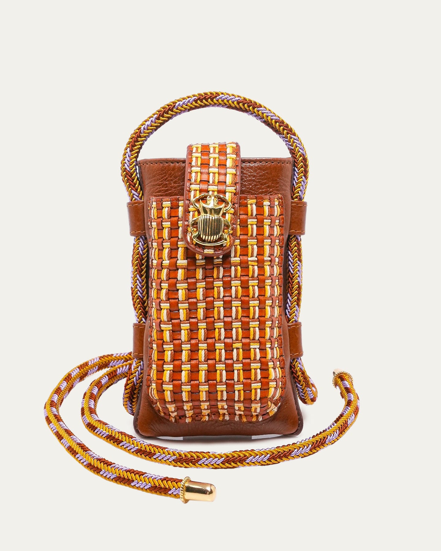 Woven handbag with a strap on a light beige background