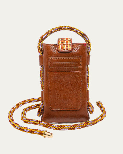 Brown leather crossbody bag with braided strap on a light beige background