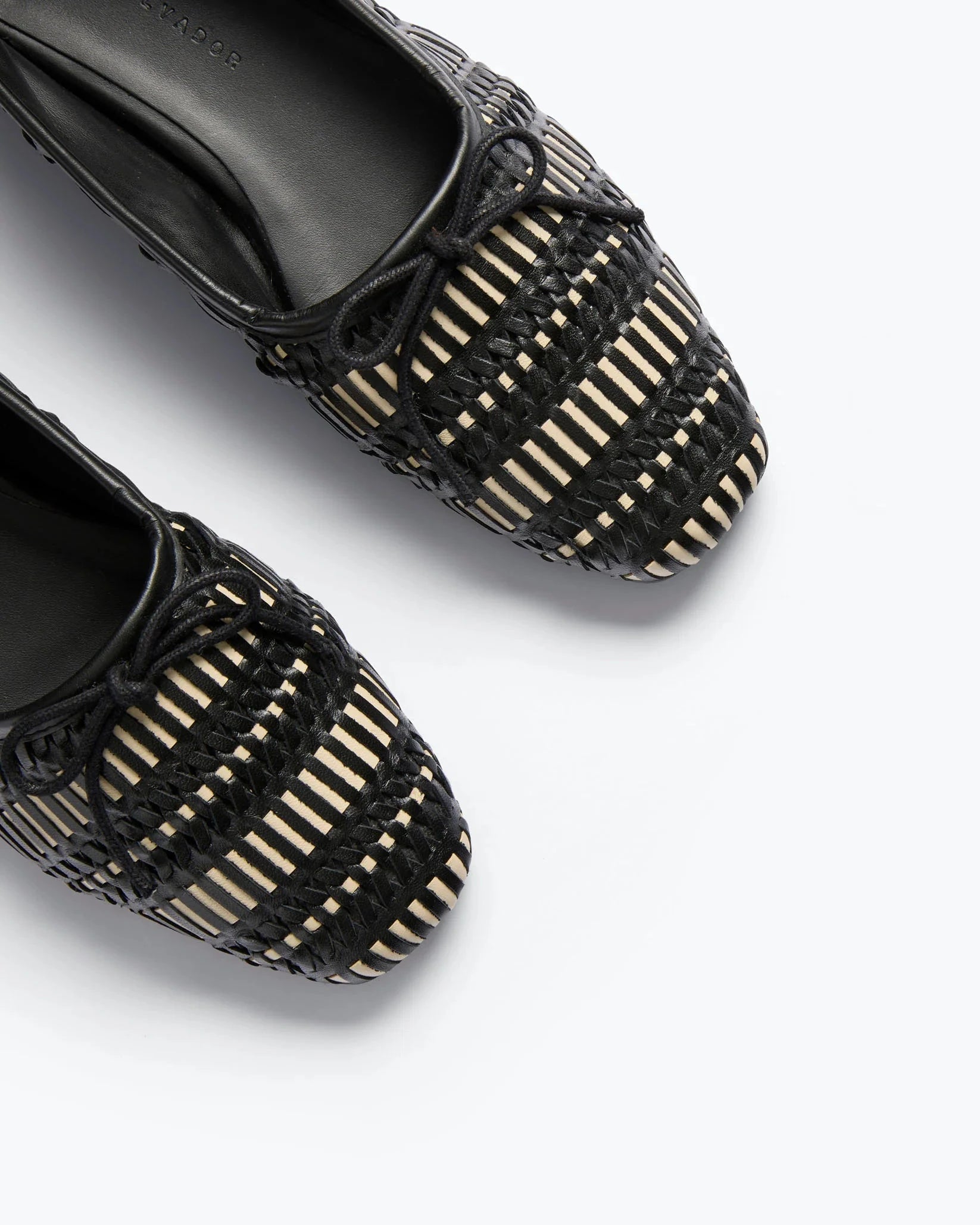 Black woven shoes on a white background