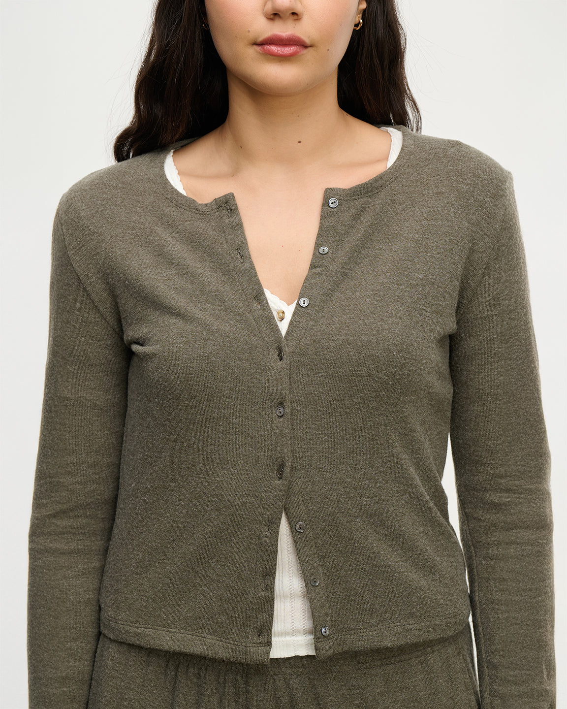 closeup of woman wearing a heathered olive cardigan