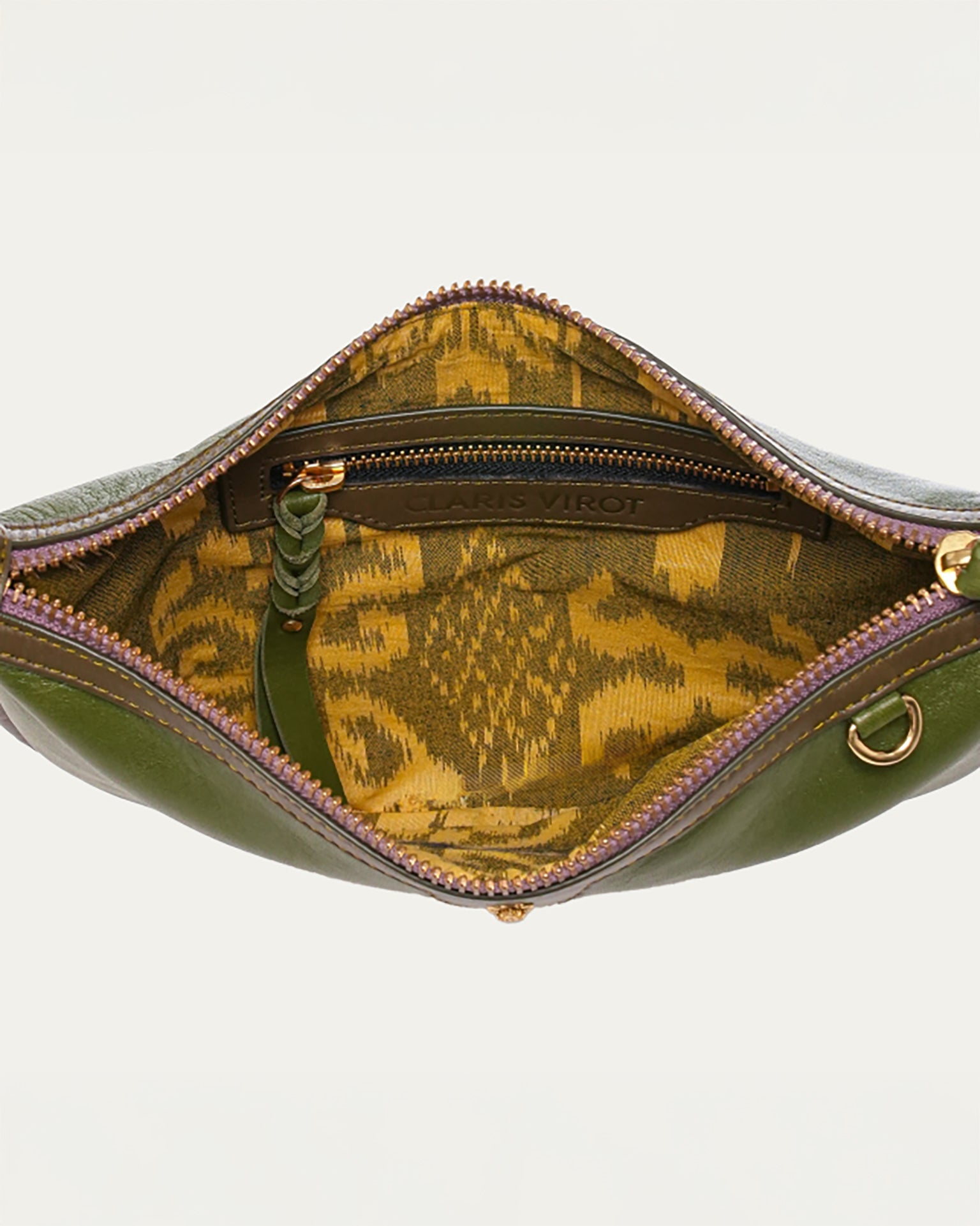 Green leather bag with gold interior pattern on a white background