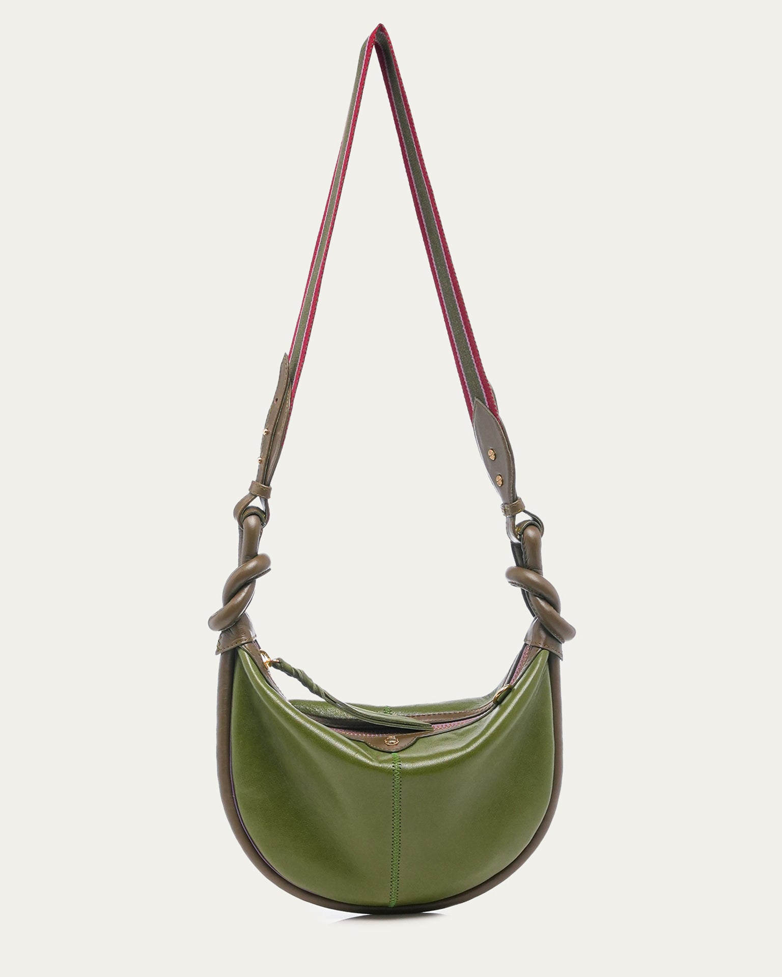 Green leather handbag with a knotted strap on a light gray background