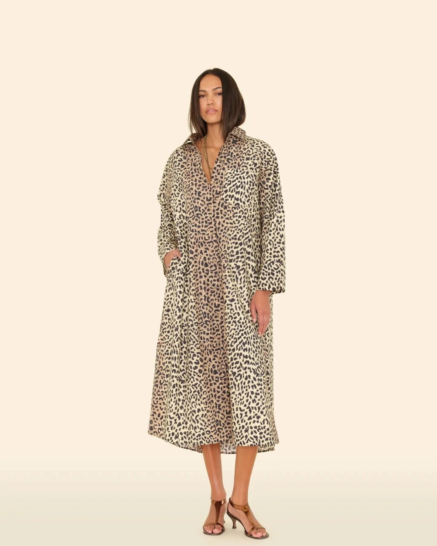 Woman wearing a leopard print dress on a beige background