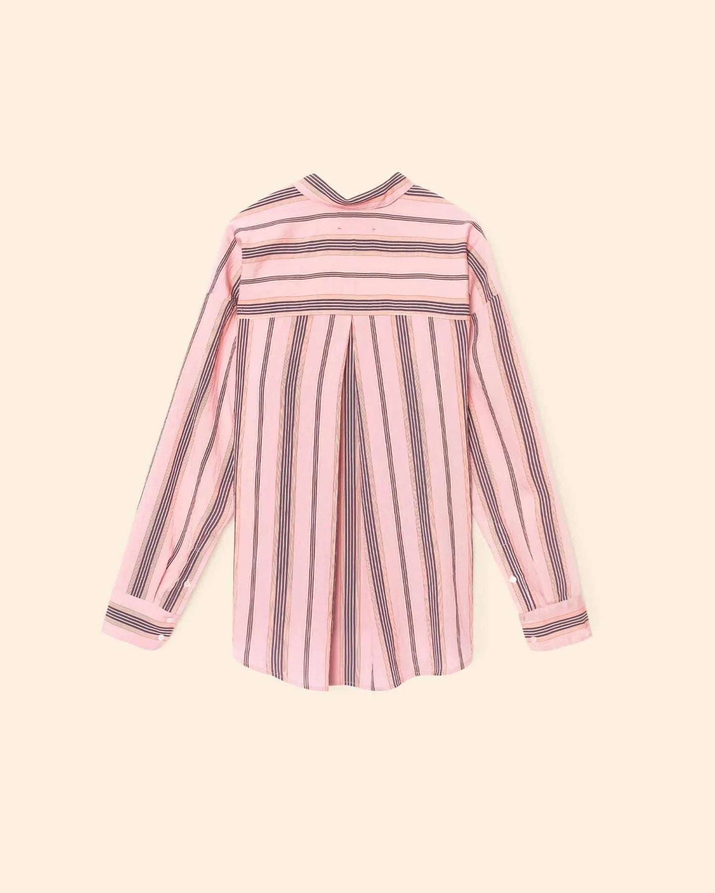 Pink and black striped dress on a beige background