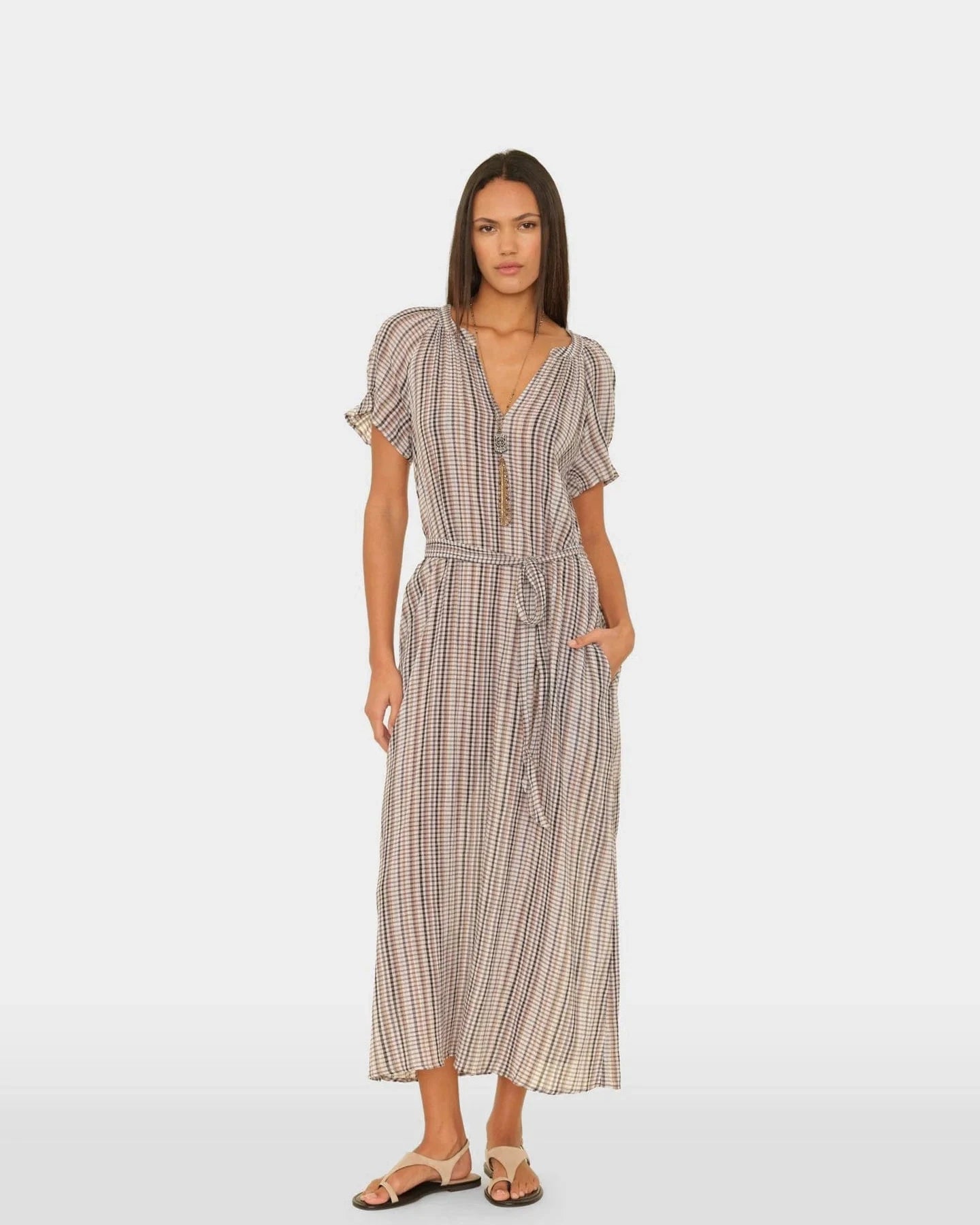 Woman wearing a patterned dress on a white background