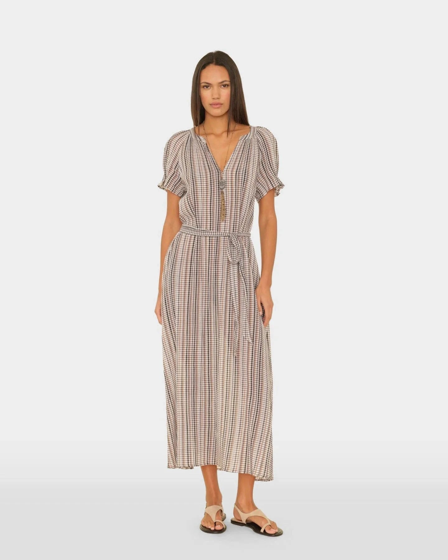Woman wearing a striped dress on a white background