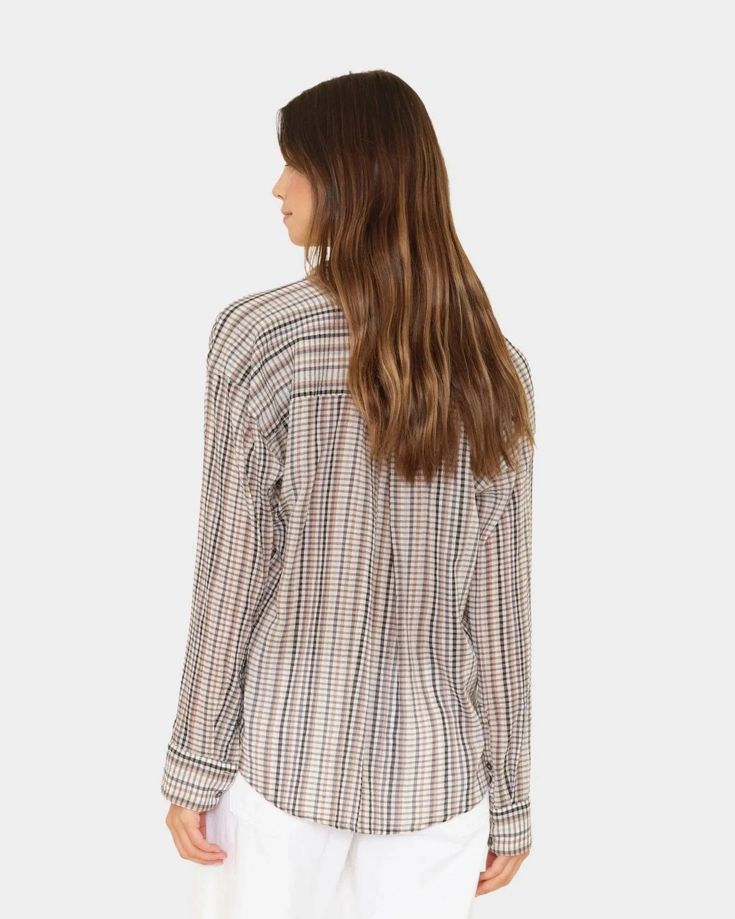 Woman wearing a checkered shirt on a white background