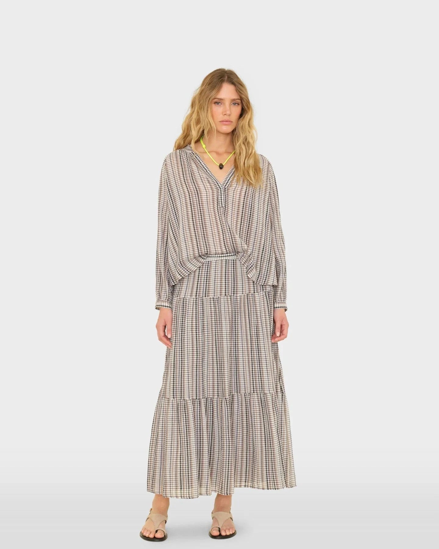 Woman wearing a checkered dress on a white background