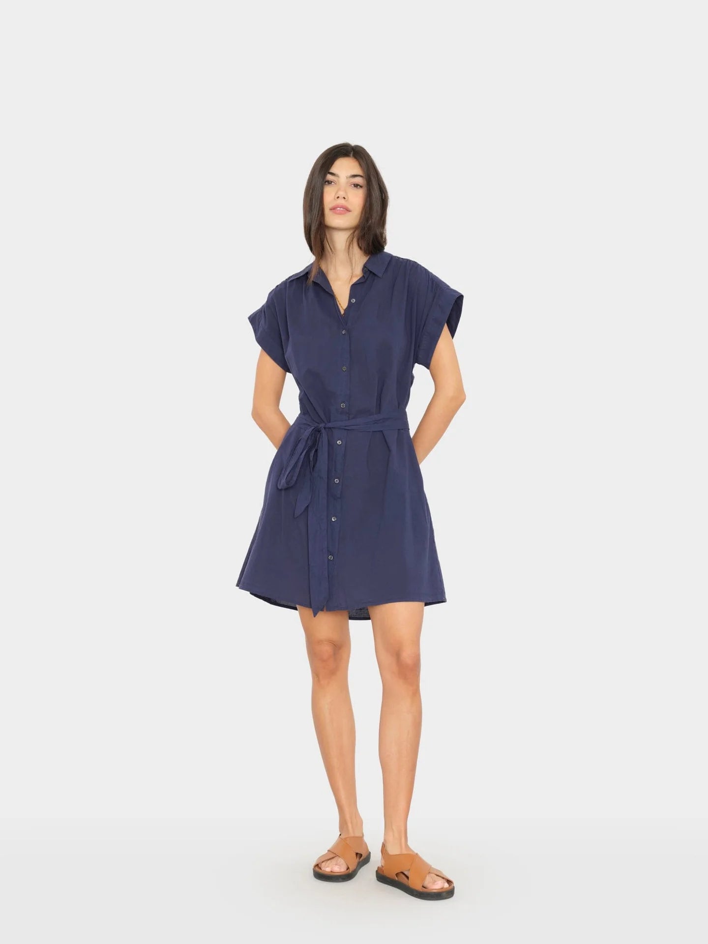 Woman wearing a navy blue dress on a white background