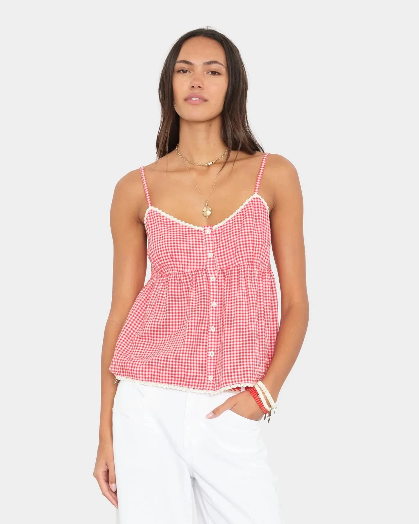 Woman wearing a red and white checkered top on a light gray background